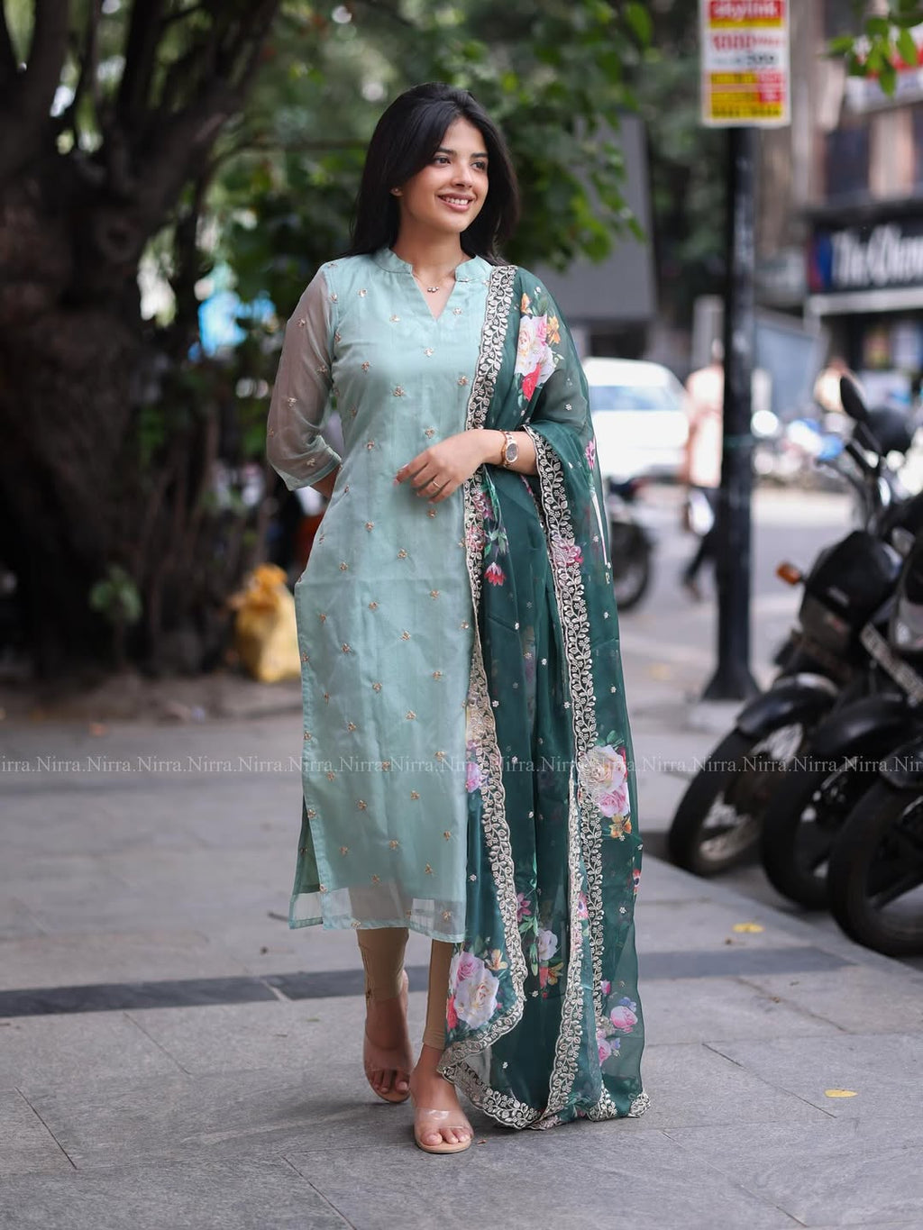 Flaunt in our turquoise green organza top paired with floral shawl salwar set